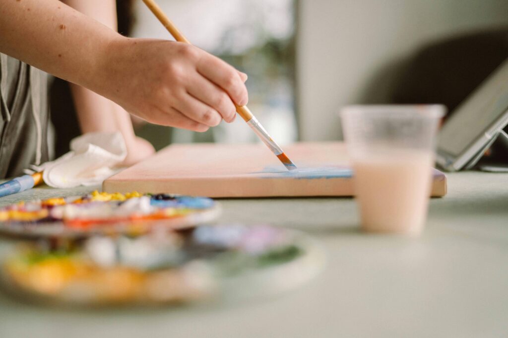 Person painting on canvas